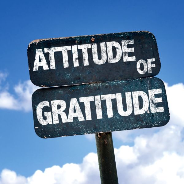 Road sign reading attitude of gratitude, which we aim to practice every day at Roslyn Pharmacy